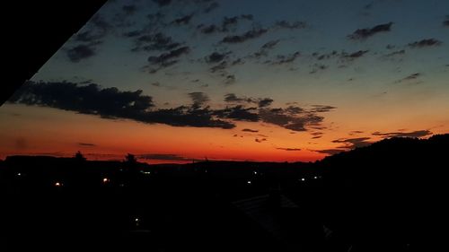 Silhouette buildings against sky during sunset