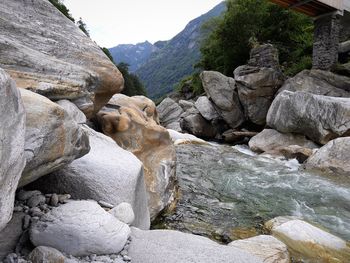 Rocks at shore against sky