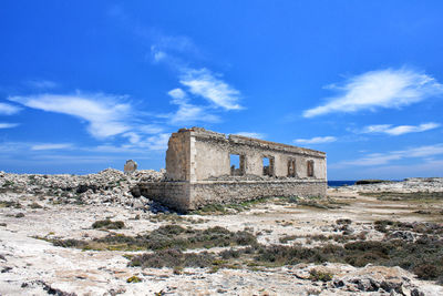 Old ruin building against blue sky