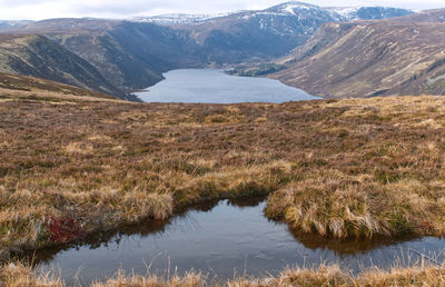 Scenic view of lake and mountains against sky