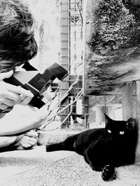 Man holding cat sitting outdoors