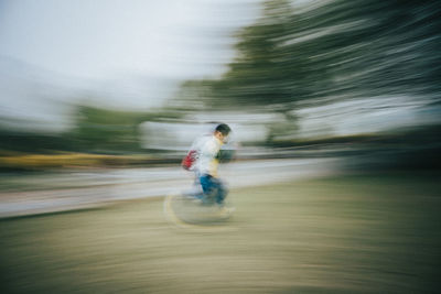 Blurred motion of man running on road