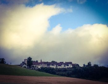 Buildings against cloudy sky