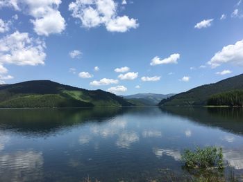 Scenic view of lake and mountains against sky