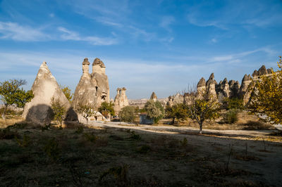 Rock formations on landscape against sky