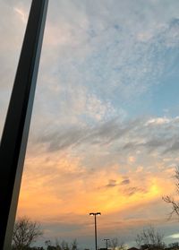 Low angle view of silhouette trees against sky