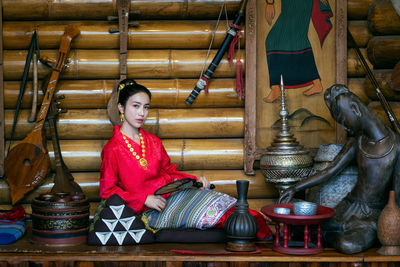 Portrait of beautiful woman sitting at store