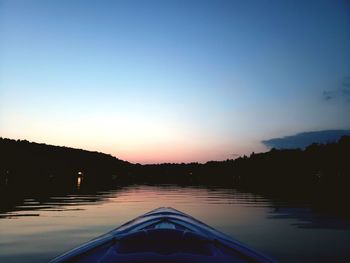 Scenic view of lake against clear sky during sunset