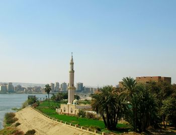 View of mosque in city against clear sky