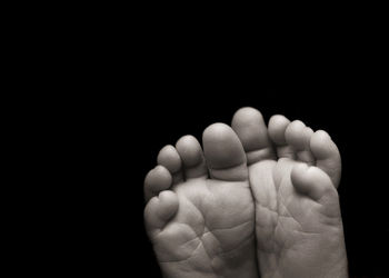 Close-up of human hand against black background