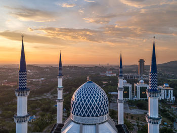 Panoramic view of buildings in city against sky during sunset