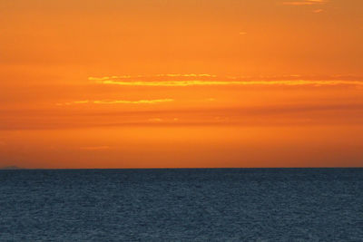 Scenic view of sea against orange sky