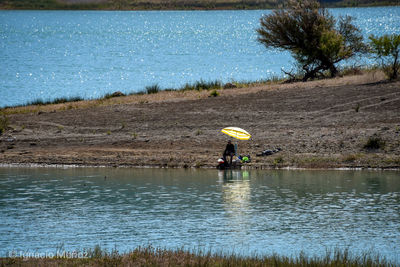 Silhouette man fishing in lake 