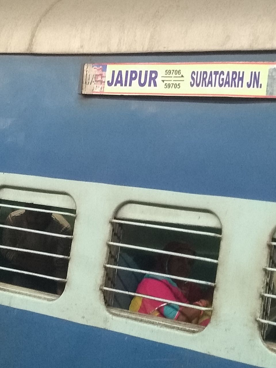 CLOSE-UP OF INFORMATION SIGN AGAINST CAR WINDOW