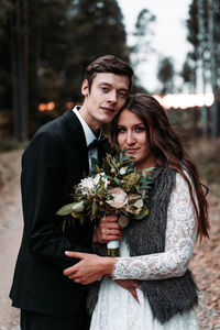 Portrait of young couple standing outdoors