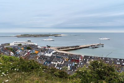 High angle view of buildings by sea against sky