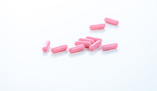 Close-up of pills over white background