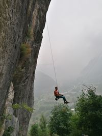 Man on rock against mountains