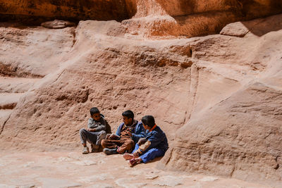 People sitting on rock