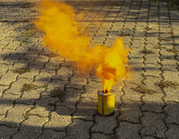 High angle view of yellow fire on footpath