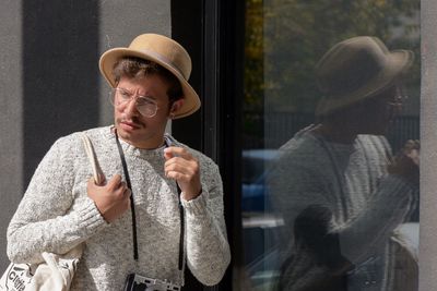Young man looking through window