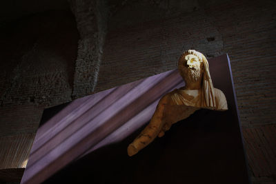 Low angle view of woman lying on wall