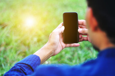 Midsection of man using mobile phone