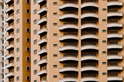 Full frame shot of apartment building balconies in city