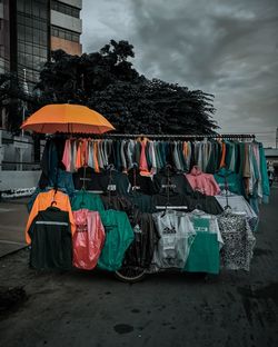 Rear view of multi colored umbrella against buildings