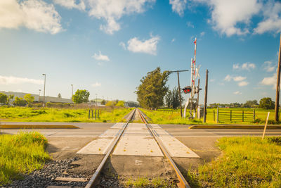 Railroad tracks by trees against sky