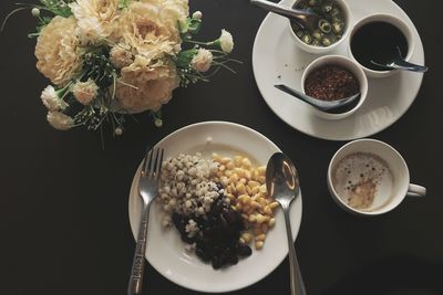 High angle view of breakfast in plates on table