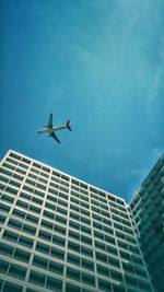 Low angle view of airplane flying in sky