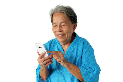 Mid adult man using smart phone against white background