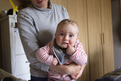 Portrait of mother and daughter at home