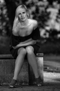 Portrait of a smiling young woman sitting outdoors