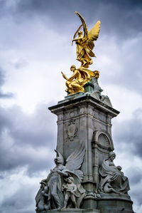 Low angle view of statue against cloudy sky