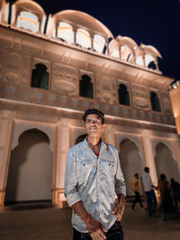 Portrait of woman standing outside historic building