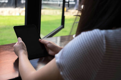 Midsection of woman using mobile phone