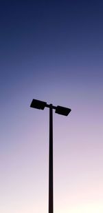 Low angle view of silhouette pole against clear sky during sunset