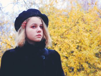 Portrait of a beautiful young woman in autumn