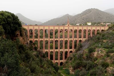 Arch bridge against mountain