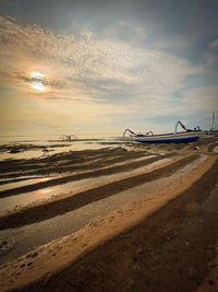 Scenic view of beach against sky during sunset