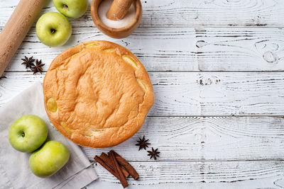 Traditional charlotte apple pie charlotte on white wooden table with fresh apple and cinnamon ,