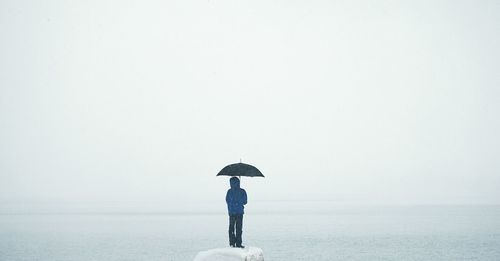 Rear view of woman standing in water