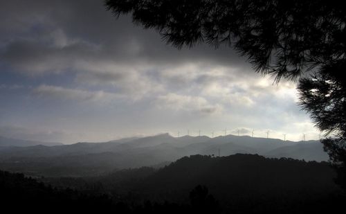 Scenic view of silhouette mountains against sky