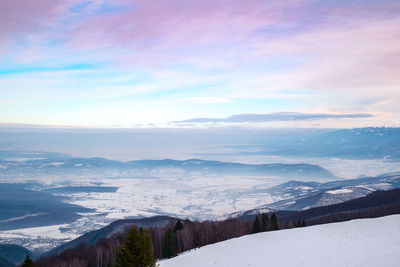 Scenic view of snow covered mountains against sky