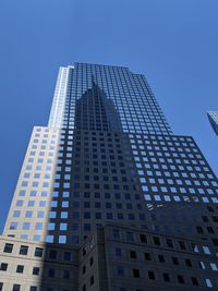 Low angle view of modern building against clear blue sky