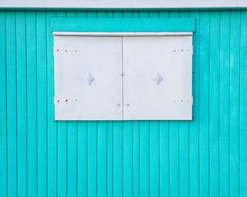 Closed window of blue building