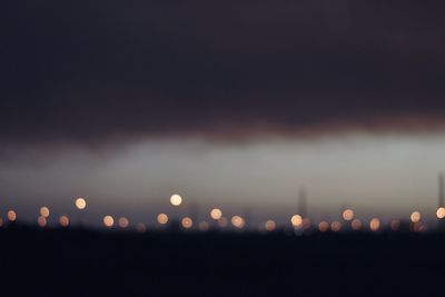 Close-up of illuminated lights in city at night