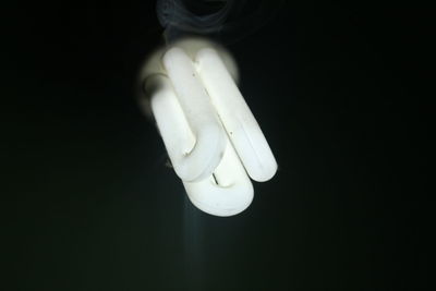 Close-up of light bulb against black background